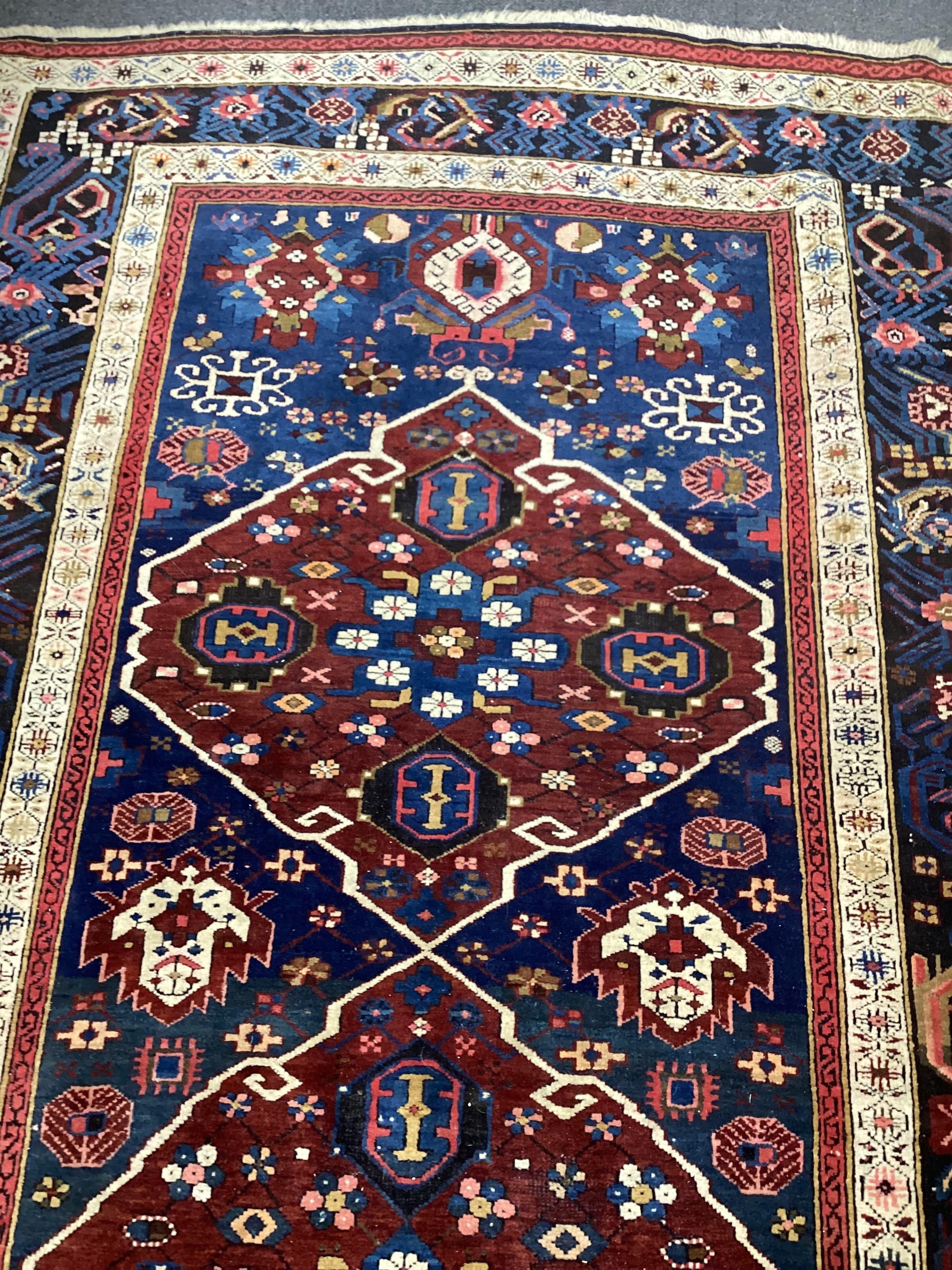 A South Caucasian blue ground runner, the field woven with five red lozenge panels, 390 x 118cm